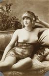 (POSTCARDS) An album containing 54 risqué real photo postcards and photographs featuring female subjects,